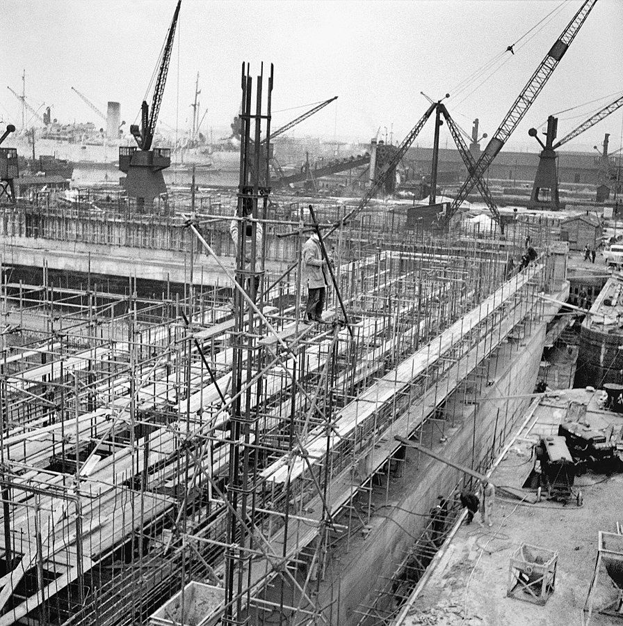 Phoenix concrete caissons part of the Mulberry artificial harbour being constructed in Surrey Docks in Rotherhithe London 17 April 1944 Laing
