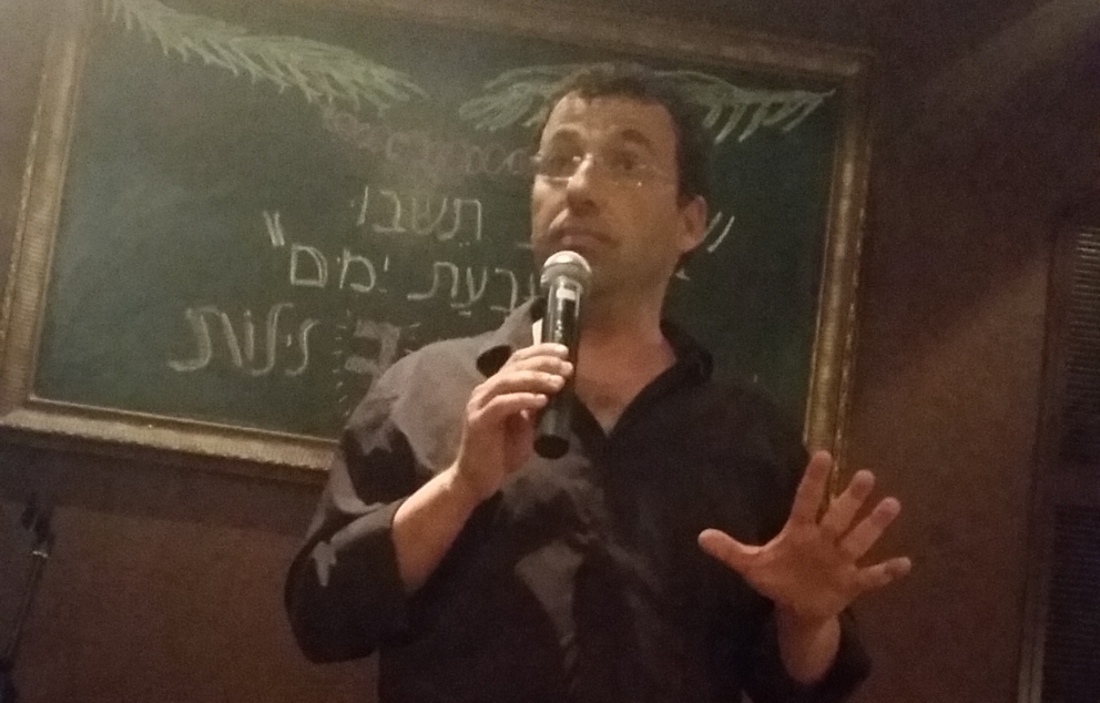 רביב דרוקר במהלך הרצאה בחיפה, 2016   מקור: ויקיפדיה (אלפר)